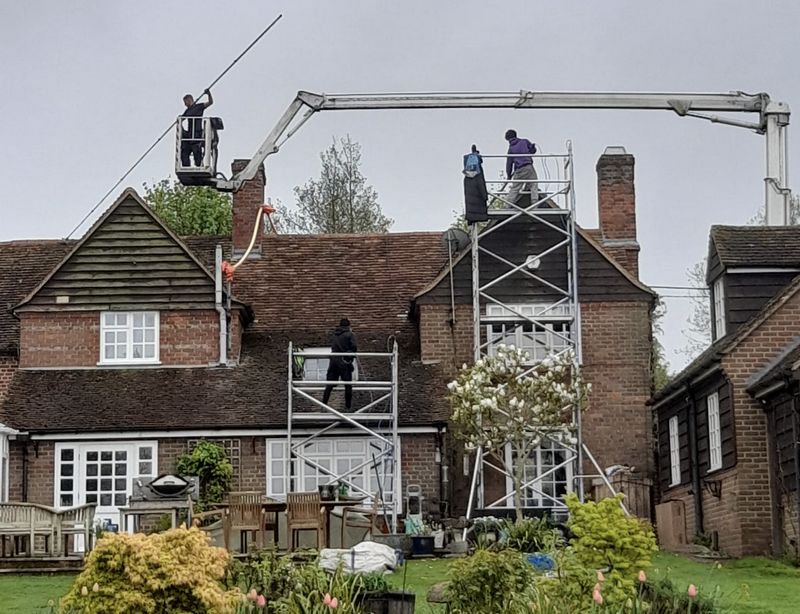 The Roof Moss Cleaners using cherry picker and scaffolding to clean roof safely and professionally in Eastcotts, Bedfordshire